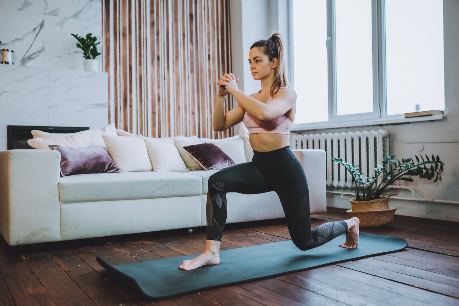 A person doing squats to build leg strength and protect the brain