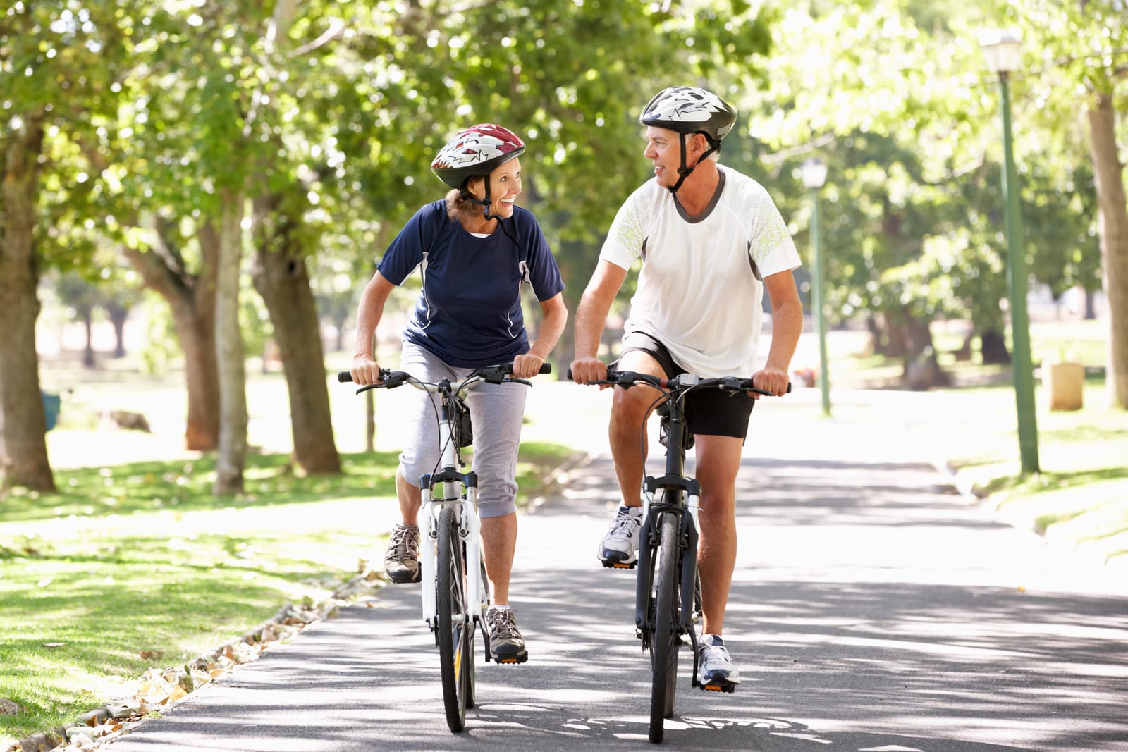 Couple Cycling Helmets Park