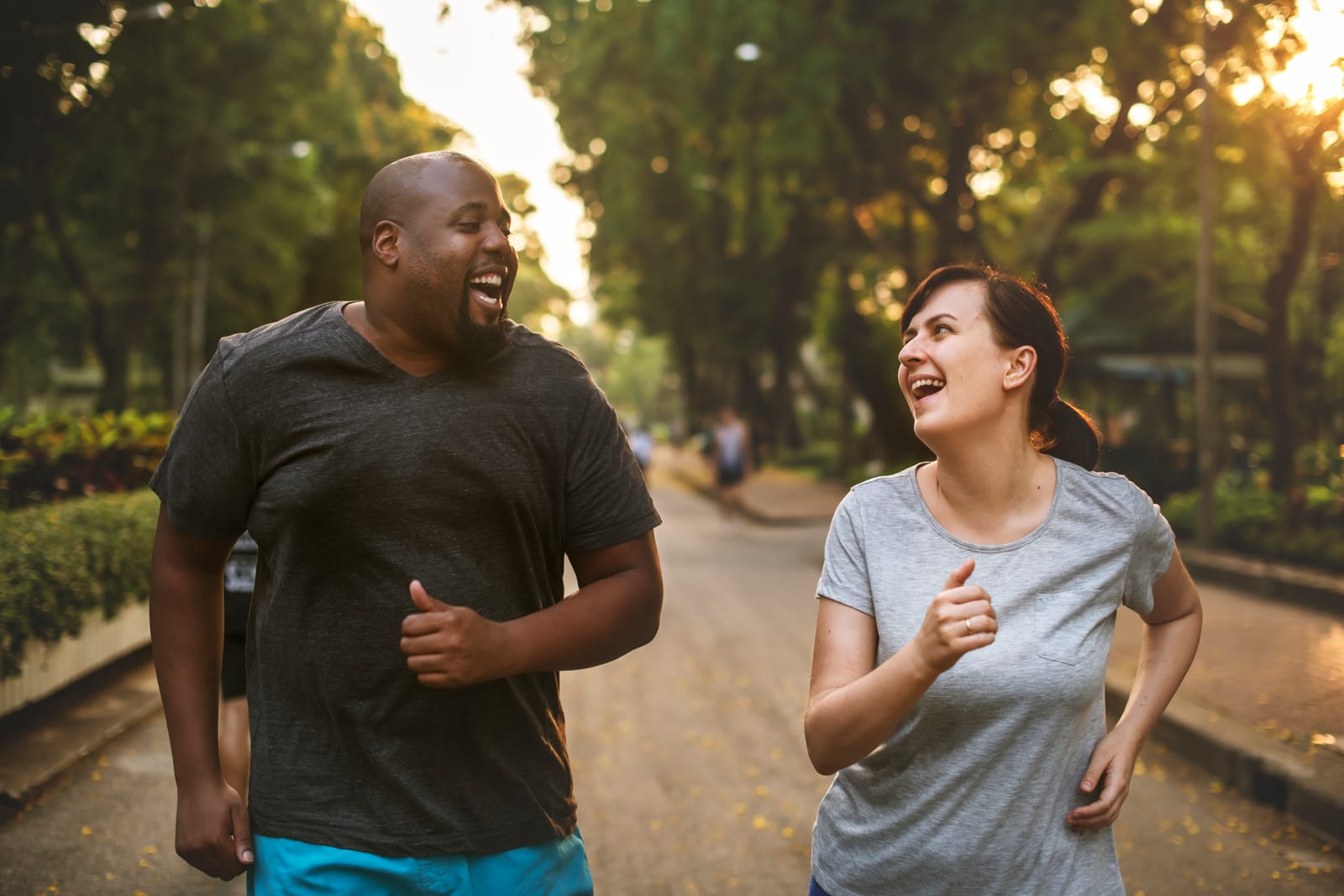 Couple Jogging Tree Lined Path