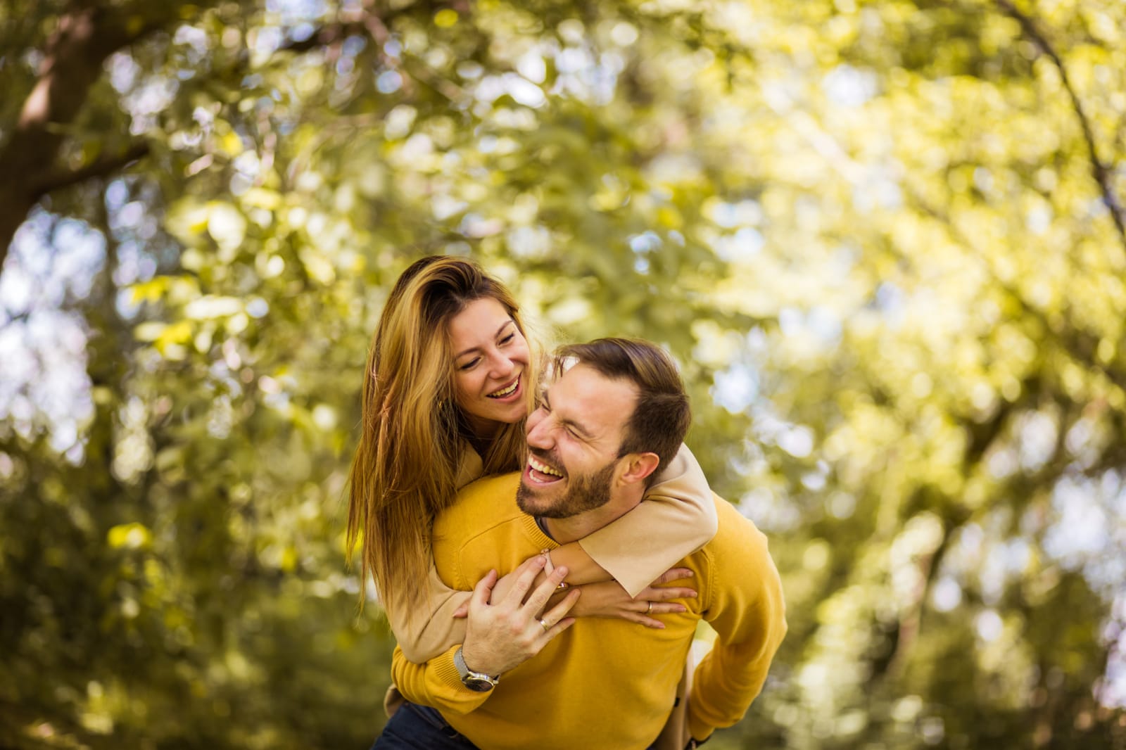 Couple Piggyback Park Laughing