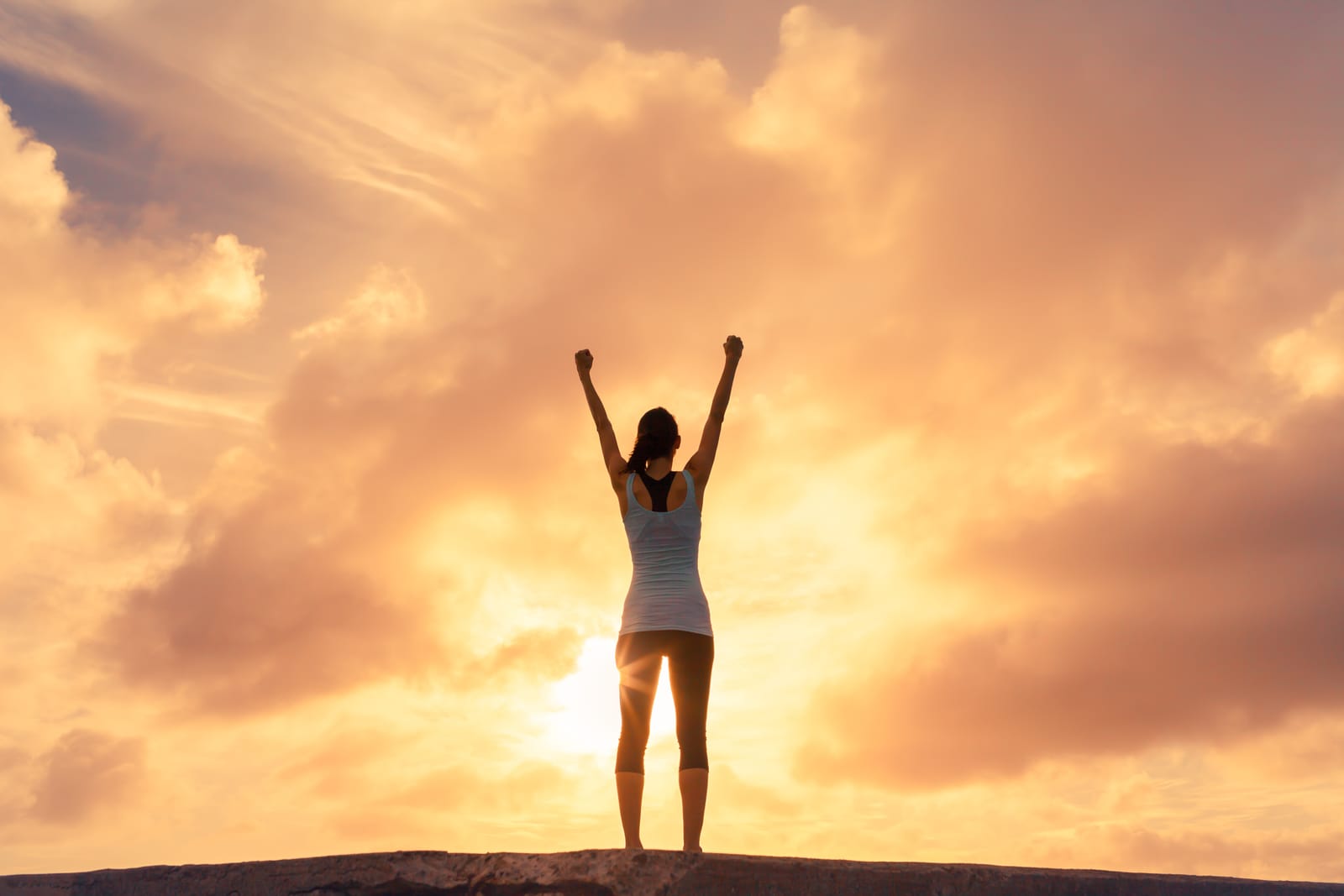 Woman Arms Raised Sunset Cliff