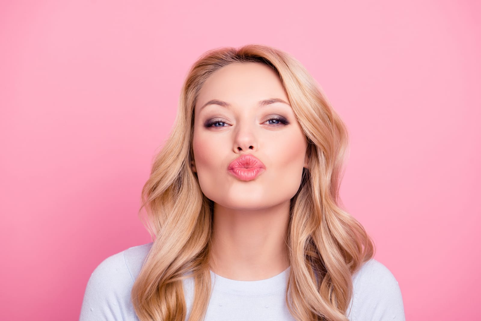 Blonde Woman Blowing Kiss Pink