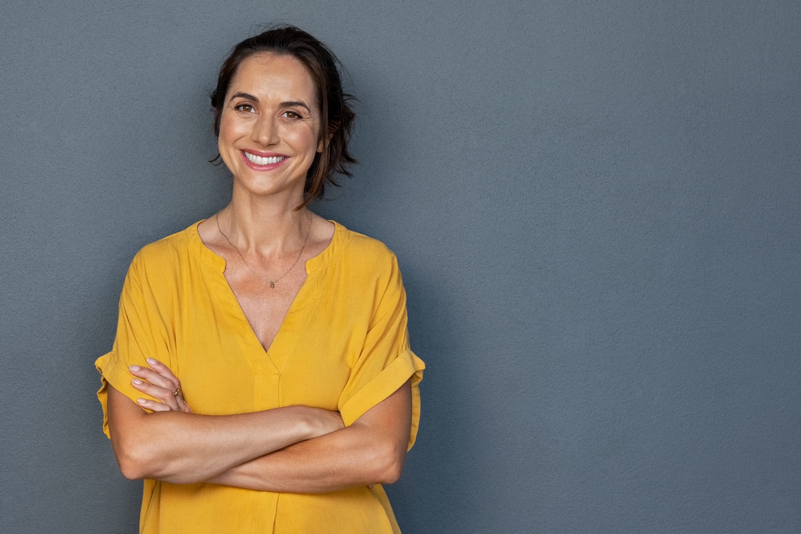 Confident Woman Yellow Blouse Arms Crossed