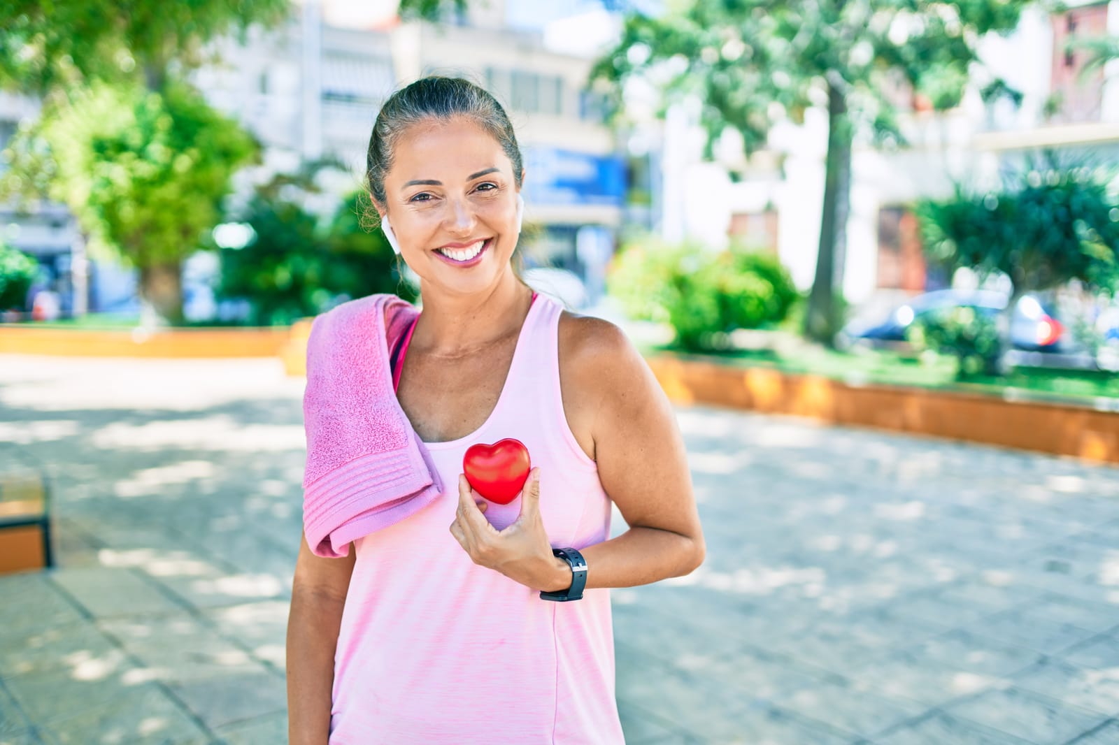 Fitness Woman Holding Red Heart