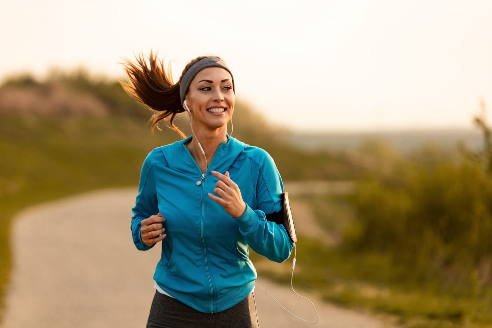 Woman Jogging Blue Jacket Sunset
