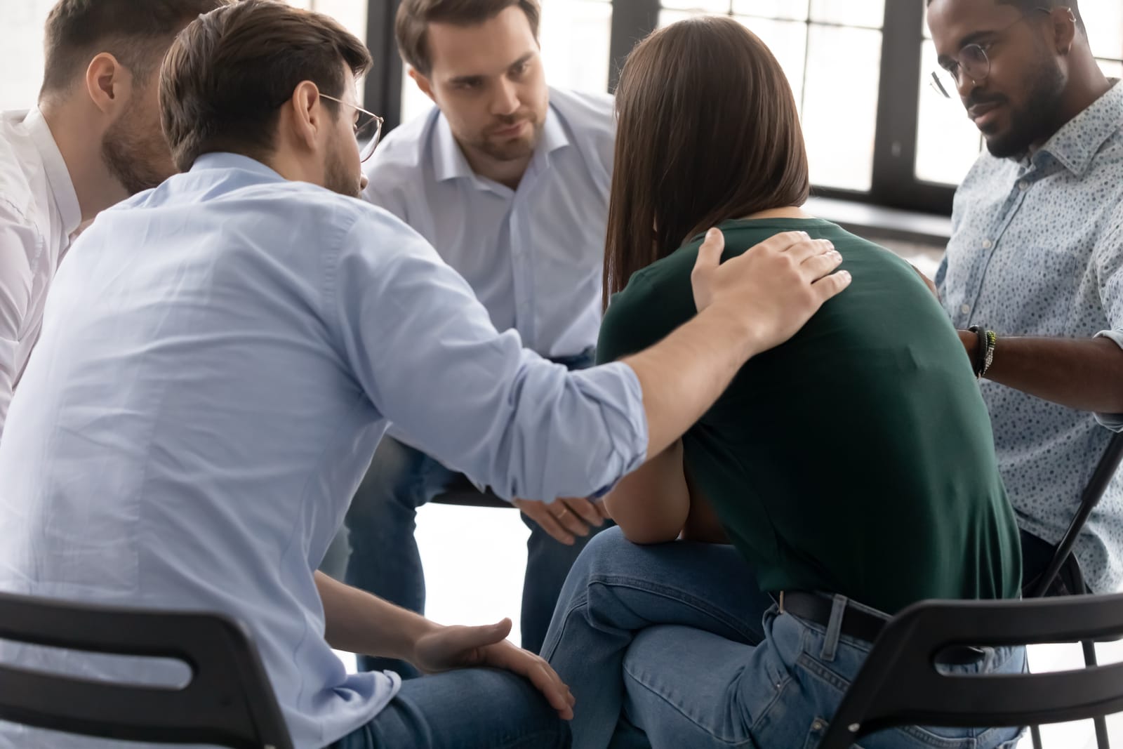 Group Comforting Distressed Woman