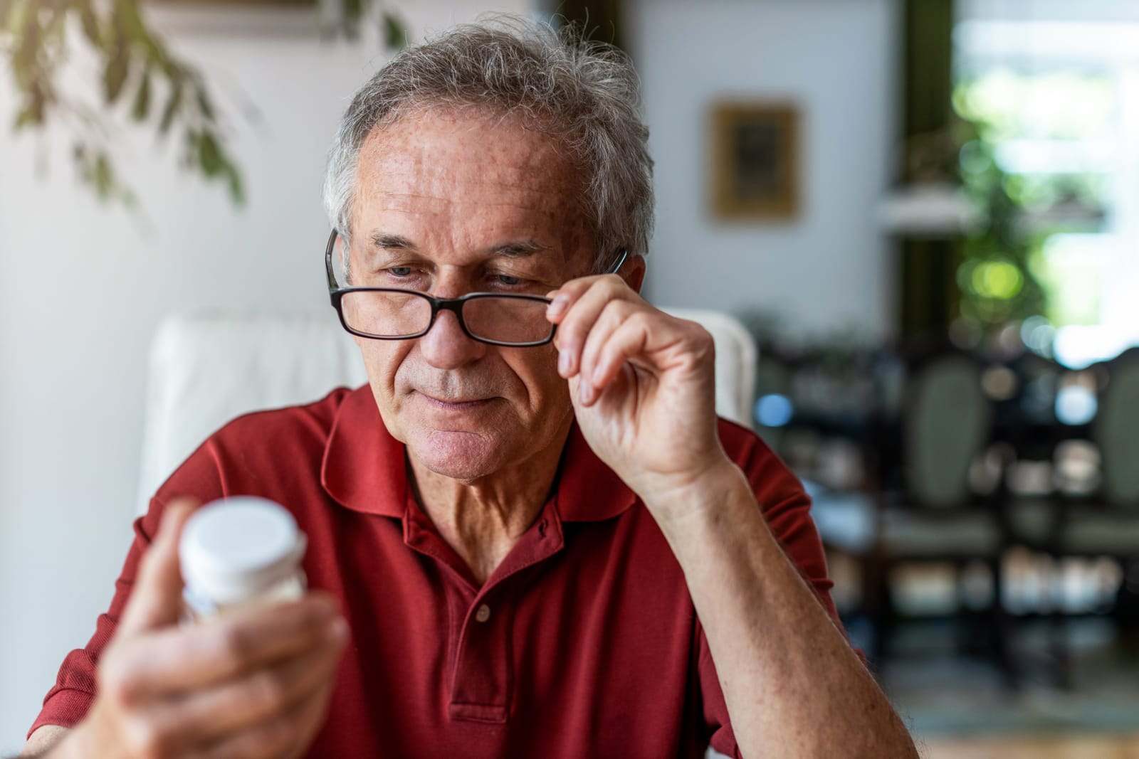 Senior Man Reading Pill Bottle