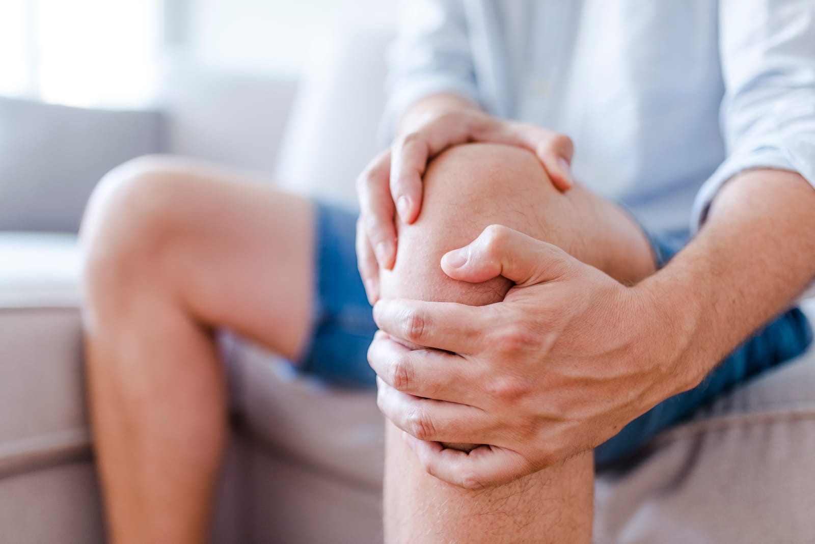 Man Clasping Knee Pain Closeup
