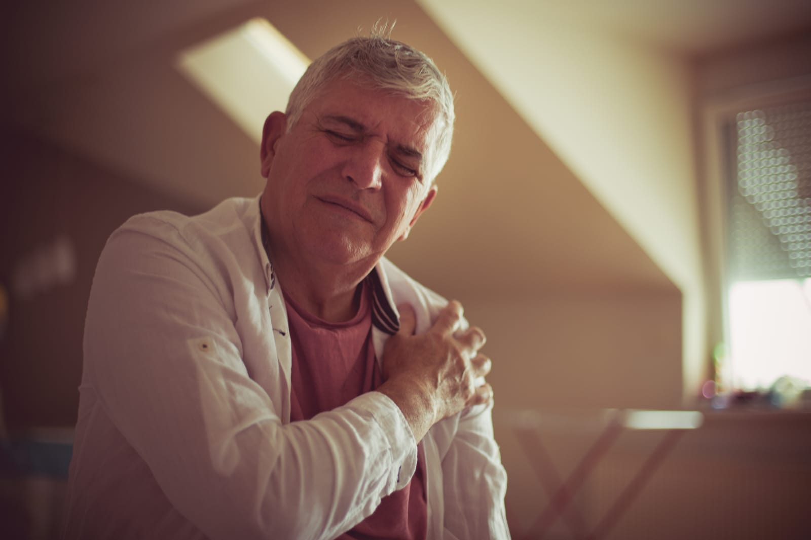 Older Man Gripping Shoulder Pain