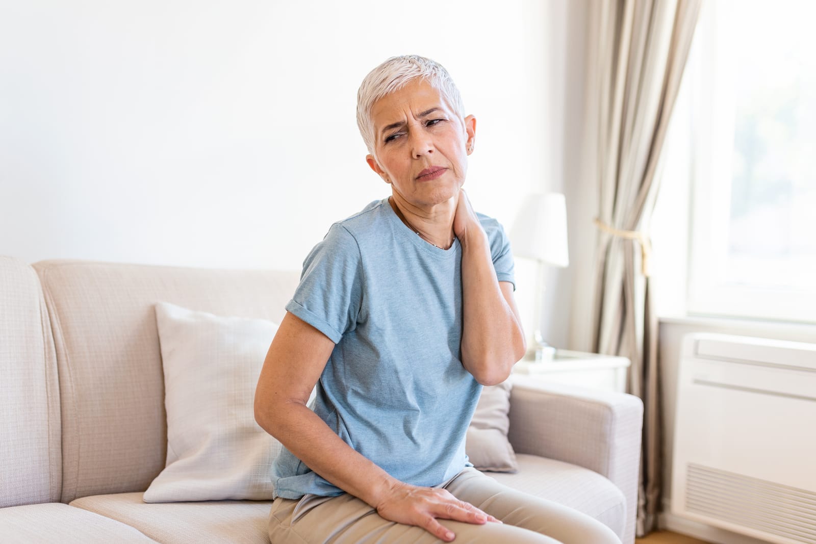 Woman Neck Pain Sitting Couch