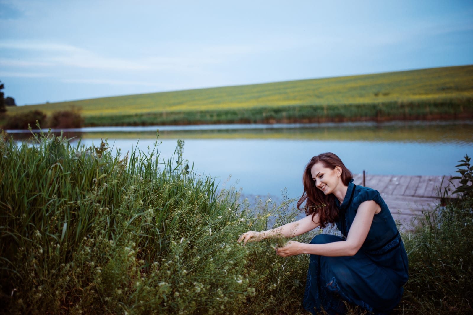 Woman Picking Herbs Lakeside